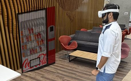 A participant in a Quest 3 facing the real vending machine the virtual one is anchored to