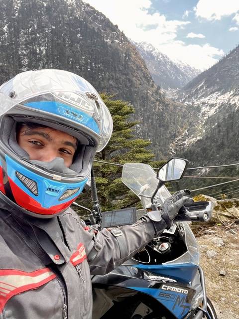 Helmet on, snow behind.