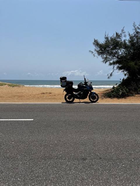 Odisha. An empty road and the Bay of Bengal.